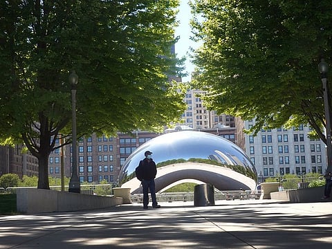 Visitors walk past the Cloud Gate sculpture in Millennium Park on June 15, 2020 in Chicago, Illinois. The park, which had been closed to visitors to help curtail the spread of the coronavirus COVID-19, partially reopened, with restrictions, to the public.