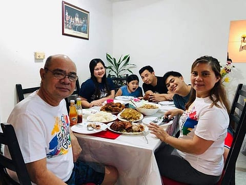 Mary Kim and her family sit down for a shared meal.