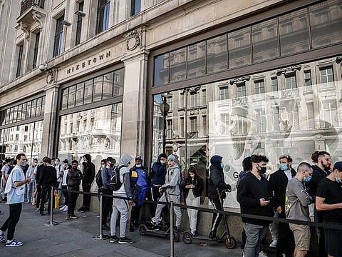 People queue outside the Niketown shop in London, Monday, June 15, 2020. After three months of being closed under coronavirus restrictions, shops selling fashion, toys and other non-essential goods are being allowed to reopen across England for the first time since the country went into lockdown in March.