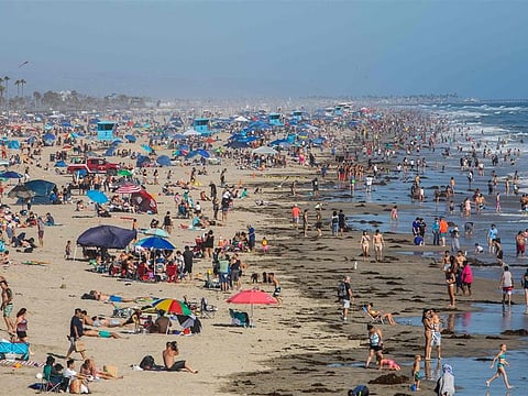 People at the beach in Huntington Beach, California, on Sunday, June 14, 2020, amid the coronavirus pandemic.Apu Gomes / AFP - Getty Images