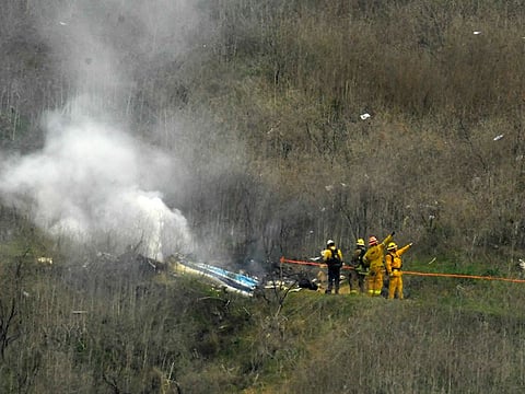 Firefighters work the scene of a helicopter crash where former NBA star Kobe Bryant died in Calabasas, California on January 26, 2020.