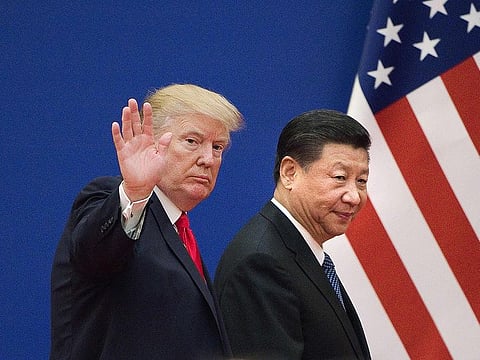 US President Donald Trump (L) and China's President Xi Jinping leave a business leaders event at the Great Hall of the People in Beijing on November 9, 2017.