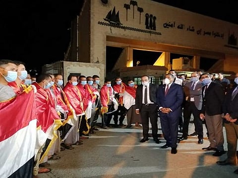 Egyptians, returning from Libya, are received at the Al Saloum border crossing.