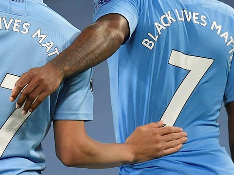 English Premier League players wear 'Black Lives Matter' messages on their shirts.