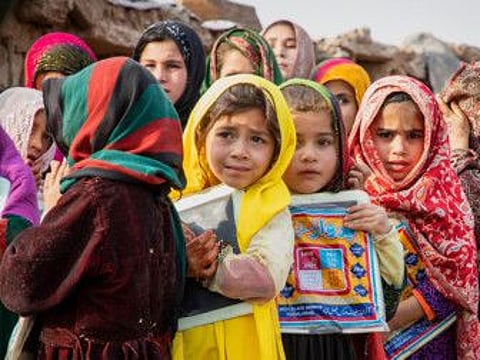 Afghan refugee children stand outside a school in Islamabad, Pakistan, home to around 3,000 Afghan refugees. Image Credit - UNHCRRoger Arnold