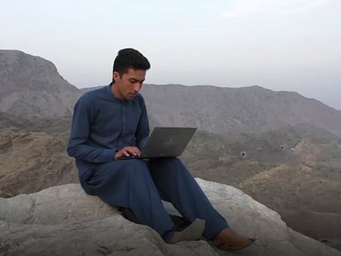 Students in Pakistan's tribal areas climb a mountain to get internet connection