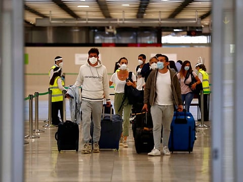 Passengers, wearing protective face masks, walk upon arrival from Paris at Adolfo Suarez Barajas airport as Spain reopens its borders to most European visitors after the coronavirus lockdown, in Madrid, Spain, June 21.