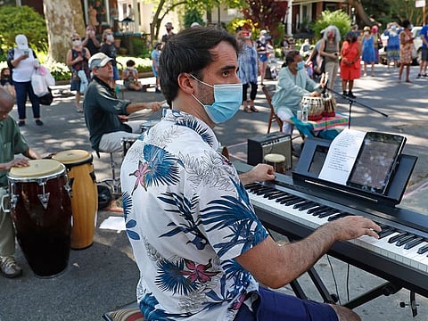 Albert Marquès plays keyboard along with other musicians in front of the home of Roy Nathanson as part of Make Music-New York in Brooklyn's Ditmas Park neighbourhood during the coronavirus outbreak, Sunday, June 21, 2020.