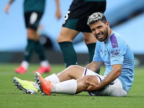 Manchester City's Sergio Aguero reacts as he sits on the pitch injured.
