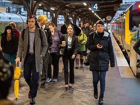 Passengers walk along a platform at Wellington Railway Station in Wellington, New Zealand.