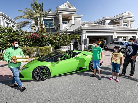 Muhammad Jehanzeb, managing director of Pakistan Supermarket delivering the mangoes at the residence of Arshad Khan and kids Ayaan and Aiza in Lamborghini.