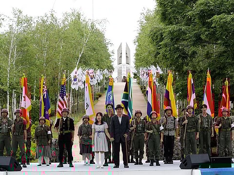 Actors wearing military uniforms with flags of countries which participated in the Korean War perform during a ceremony to mark the 70th anniversary of the outbreak of the Korean War in Cheorwon, near the border with North Korea, South Korea, Thursday, June 25, 2020.