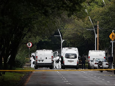 Forensic investigators and police work the scene where security secretary, Omar García Harfuch, was attacked by gunmen in the early morning hours in Mexico City, Friday, June 26, 2020.