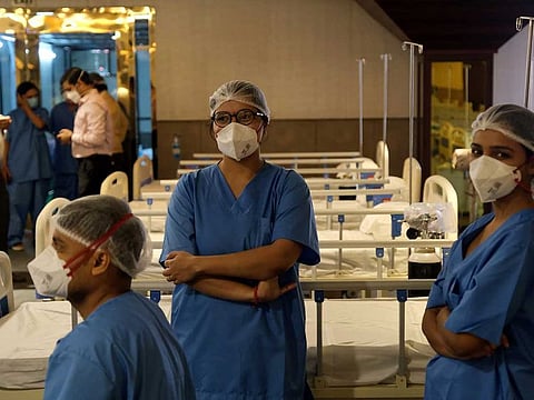 Doctors and other health workers gather in a makeshift ward at an emergency Covid-19 care centre in Lok Nayak Jai Prakash Hospital in New Delhi