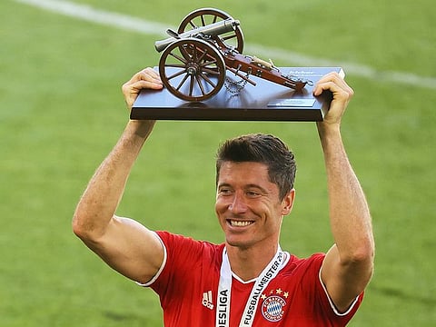 Bayern Munich's Robert Lewandowski celebrates with the Bundesliga top scorer trophy