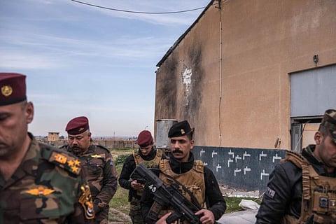 Iraqi soldiers survey the launch site of a rocket attack that killed a US civilian contractor at a military base in Kirkuk, Iraq, January 16, 2020. Iraqi forces raided an Iranian-backed militia suspected of carrying out a spate of rocket attacks against American forces, making good on the new prime minister’s promise to crack down on armed groups that have strained relations with the US.