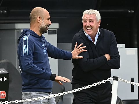 Manchester City's Pep Guardiola shares a joke with Newcastle's Steve Bruce