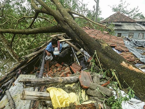 The morning after: A man comes out from the wreckages of what used to be his home the day after Cyclone Amphan ravaged West Bengal in May.