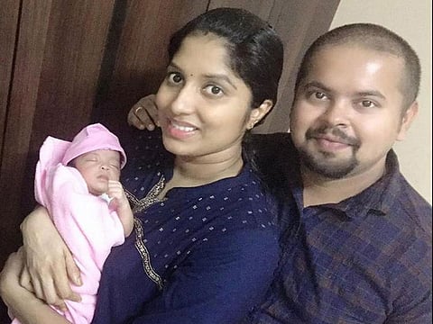 Jincy Antony with her husband and their newborn.
