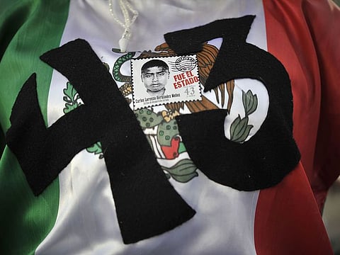 A woman joins the parents of 43 missing students from Ayotzinapa teachers school during a march in Mexico City, 18 months after their disappearance, in 2016.