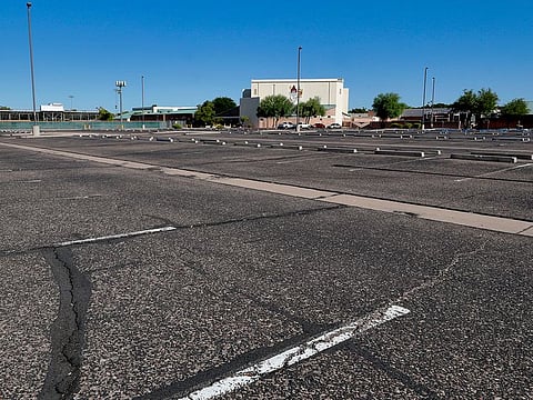 A parking lot is empty at a local high school Tuesday, June 30, 2020, in Tempe, Arizona.