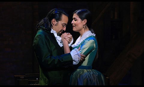 In this image released by Disney Plus, Lin-Manuel Miranda portrays Alexander Hamilton, left, and Phillipa Soo portrays Eliza Hamilton in a filmed version of the original Broadway production of "Hamilton."