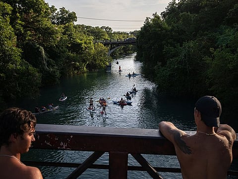 People are gathered in the waters of Barton Creek in Austin, Texas., on Tuesday, June 30, 2020.