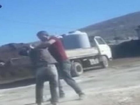 Boy in the green shirt as he was trying to escape.