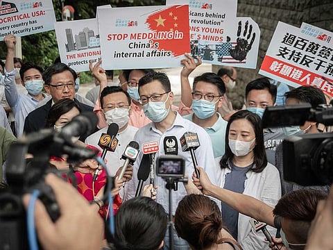 Stanley Ng Chau-pei, Hong Kong deputy to the National People's Congress, centre, speaks to members of the media during a demonstration to deliver a petition against "American and foreign meddling in China's internal affairs" to the US consulate in Hong Kong, China, on Thursday, July 2, 2020.