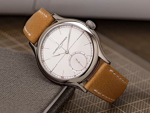 The white-silver opaline dial has a slate grey hour circle and burgundy numerals.
