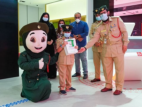 Dubai Police with the boy in a smart police station