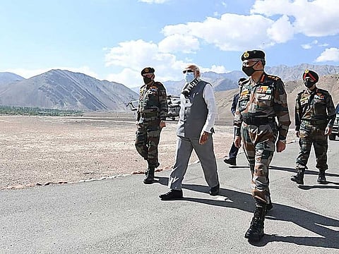 India's Prime Minister Narendra Modi (C) arrives in Leh, the joint capital of the union territory of Ladakh, on July 3, 2020. Prime Minister Narendra Modi made a surprise visit to India's northern frontier region with China on July 3 in his first trip to the area since a deadly border clash last month.