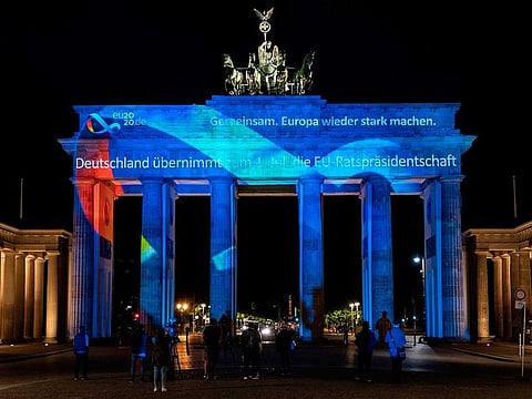 The logo and motto ("Together. For Europe's recovery") of the German presidency of the EU Council is projected on the Brandenburg Gate in Berlin on June 30, 2020. Germany will hold the rotating presidency of the EU Council for 6 months.