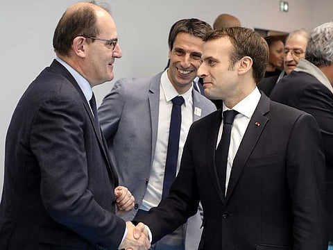 French President Emmanuel Macron shakes hands with Jean Castex (left) in Creteil, on the outskirts of Paris, on January 9, 2019. Castex replaced Edouard Philippe as prime minister.