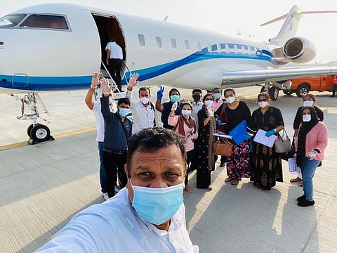 Afi Ahmed takes a selfie with other passengers who flew in to Dubai from Kochi on a business jet on Saturday.