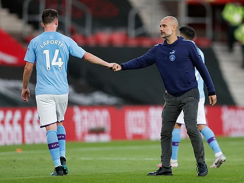 Manchester City's head coach Pep Guardiola with Aymeric Laporte.