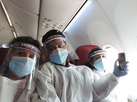 Vandana Srivastava (left) and children Kushagra and Syoni on board a Vande Bharat Mission repatriation flight from Dubai to New Delhi.