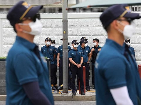 Police officers wearing face masks to help protect against the spread of the new coronavirus stand guard near the US embassy in Seoul, South Korea, Tuesday, July 7, 2020.