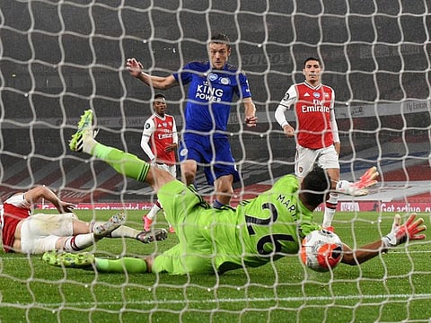 Leicester City's Jamie Vardy (blue) strikes against Arsenal during their Premiership encounter on Tuesday night.
