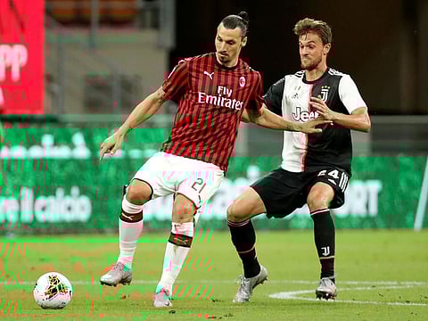 AC Milan's decorated striker Zlatan Ibrahimovic (left) being challenged by Juventus' Daniele Rugani during their Serie A clash on Tuesday.