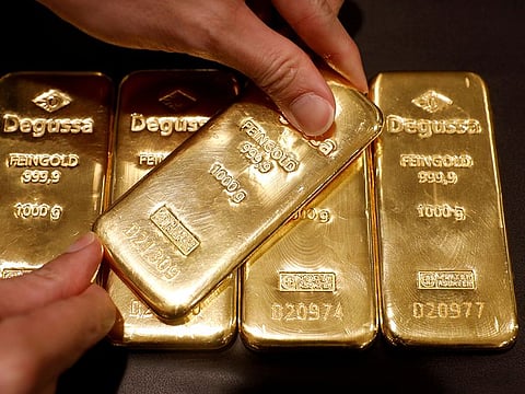 File photo: An employee shows gold bullions at Degussa shop in Singapore. India's trade deficit ballooned to an unprecedented $37.8 billion in November, driven by a four-fold increase in gold imports to a record $14.8 billion, from just $3.44 billion a year ago.