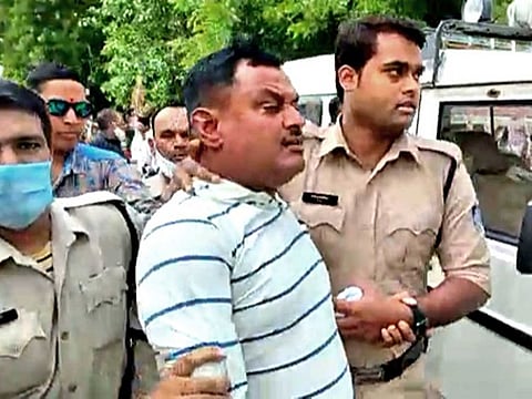 Police arrest Vikas Dubey, the main accused in the Kanpur encounter case, at the Mahakal temple, in Ujjain on Thursday.