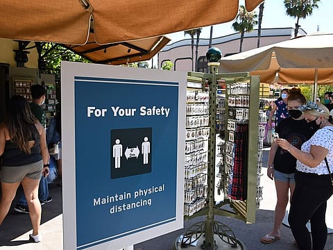 People visit Downtown Disney in Anaheim, California on July 9, 2020, the first day the outdoor shopping and dining complex has been open to the public since it closed in mid-March amid the COVID-19 pandemic.
