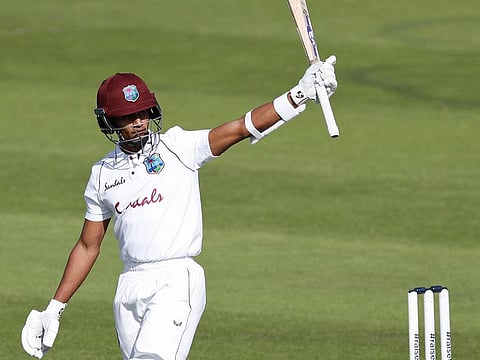West Indies' Shane Dowrich raises his bat to celebrate scoring fifty against England