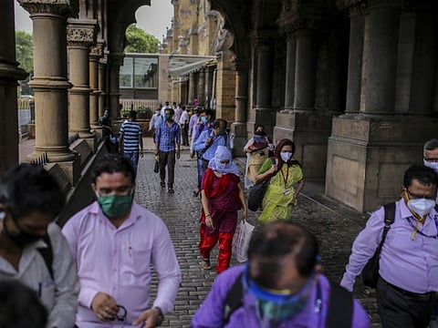 Commuters wearing protective masks exit the Chhatrapati Shivaji Maharaj Terminus (CST) railway station in Mumbai, India, on Monday, July 6, 2020.