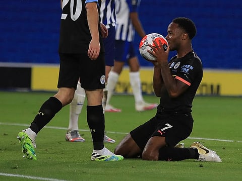 Manchester City's Raheem Sterling celebrates after scoring his side's third goal against Brighton