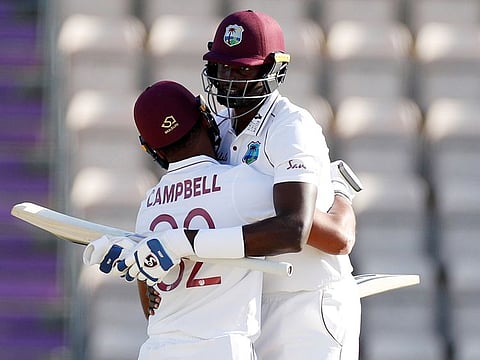 West Indies captain Jason Holder, right, hugs teammate John Campbell after their win on the fifth day of the first cricket Test match between England and West Indies, at the Ageas Bowl in Southampton, England, Sunday, July 12, 2020.