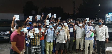 Workers with their recovered passports