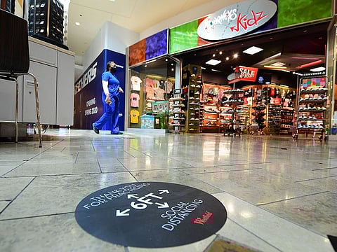 A woman walks alone through the Westfield Santa Anita shopping mall in Arcadia, California