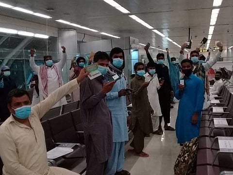 Stranded Pakistanis at the Sharjah International Airport before flying back home on a 'charity' chartered flight on Thursday morning.